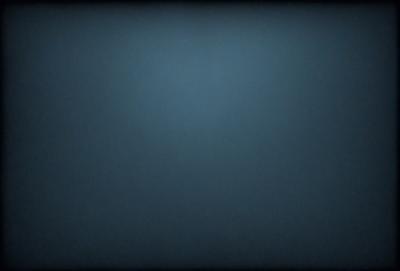 The primary subject of the image is a blue background. The setting is a dark, empty space with no visible objects or people. The visual style is a black and white photo, giving it a classic and timeless appearance. The colors and mood are predominantly dark and moody, creating a sense of mystery and depth.