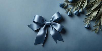 The primary subject of the image is a blue bow, which is prominently displayed on a blue background. The visual style of the image is a close-up of the bow, showcasing its details and texture. The colors and mood of the image are predominantly blue, creating a calm and serene atmosphere.
