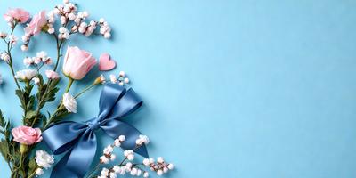 The primary subject of the image is a blue bow with white flowers attached to it. The setting is a blue background, which creates a contrast with the white flowers. The visual style is a close-up of the blue bow with flowers, showcasing the details of the flowers and the bow. The colors and mood of the image are predominantly blue and white, giving it a calm and serene atmosphere.