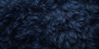 The primary subject of the image is a blue, furry fabric. The setting is a dark background, which contrasts with the blue fabric. The visual style is a close-up of the fabric, showcasing its texture and pattern. The colors and mood of the image are predominantly dark and moody, with the blue fabric serving as the main focal point.