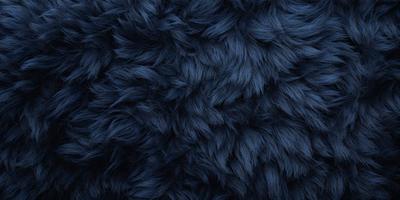 The primary subject of the image is a blue, furry fabric. The setting is a dark background, which contrasts with the blue fabric. The visual style is a close-up of the fabric, showcasing its texture and pattern. The colors and mood of the image are predominantly dark and moody, with the blue fabric serving as the main focal point.