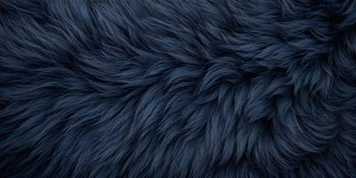 The primary subject of the image is a blue, furry fabric. The setting is a close-up of the fabric, showcasing its texture and color. The visual style is a detailed, up-close view of the fabric. The dominant colors are blue and purple, creating a calm and soothing atmosphere.