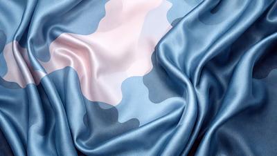 The primary subject of the image is a blue and white fabric, which is the main object, scene, or focus of the image. The setting or background is a blue cloth, and the visual style is a photo. The colors and mood of the image are predominantly blue and white, creating a calm and serene atmosphere.