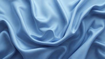The primary subject of the image is a blue fabric, which is the main object, scene, or focus of the image. The setting or background is a blue sky, and the visual style is a photo. The dominant colors and overall atmosphere are blue and serene.