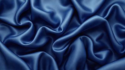 The primary subject of the image is a blue fabric, which is the main object, scene, or focus of the image. The setting or background is a blue cloth, and the visual style is a photo. The dominant colors and overall atmosphere are blue and purple, creating a calm and serene mood.