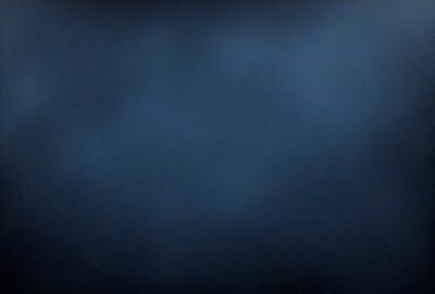 The primary subject of the image is a dark blue sky with a few clouds. The setting is a cloudy day, and the visual style is a photo. The colors and mood of the image are predominantly dark and moody, with the blue sky and clouds creating a dramatic atmosphere.