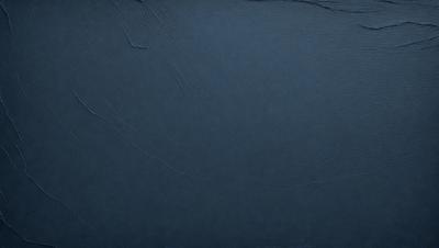 The primary subject of the image is a blue surface, which appears to be a piece of fabric or a wall. The setting is a dark room, and the visual style is a close-up of the blue surface. The colors and mood of the image are predominantly dark and moody, with the blue surface being the main focus.