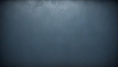 The primary subject of the image is a blue sky with a few black specks scattered throughout. The setting is a cloudy day, and the visual style appears to be a photo. The colors in the image are predominantly blue, with the black specks adding contrast. The overall atmosphere of the image is calm and serene.
