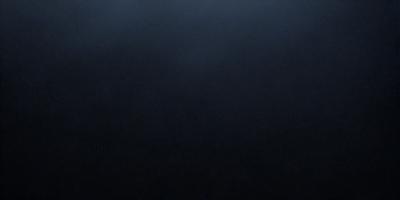 The primary subject of the image is a dark, empty space with no visible objects or details. The setting is a black background, which creates a stark contrast with the darkness of the space. The visual style is a black and white photo, which adds a sense of depth and contrast to the image. The colors and mood are predominantly dark and moody, with no bright or vibrant elements in the scene.
