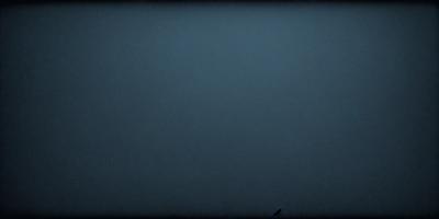 The primary subject of the image is a large, empty, and dark space. The setting is a black background, which creates a dramatic and moody atmosphere. The visual style is a black and white photo, which adds a sense of depth and contrast to the scene. The colors and mood of the image are predominantly dark and mysterious, with the black background and the lack of any visible objects or details contributing to the overall ambiance.