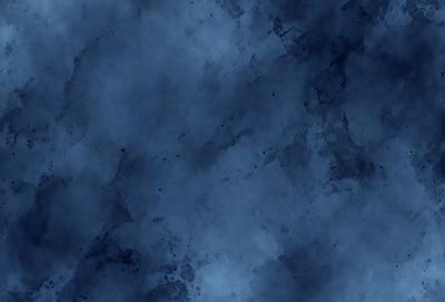 The primary subject of the image is a blue sky with clouds. The setting is a blue background, and the visual style is a photo. The colors and mood of the image are predominantly blue, creating a calm and serene atmosphere.