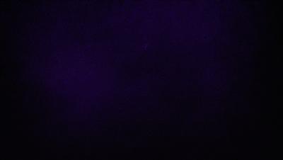 The image is a black and white photo of a dark purple sky. The sky is filled with a few stars, creating a sense of depth and space. The overall atmosphere is calm and serene, with the darkness of the sky and the stars providing a sense of tranquility.