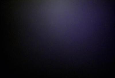 The primary subject of the image is a dark, purple background. The setting is a black background, which creates a dramatic and moody atmosphere. The visual style is a simple, monochromatic design. The colors and mood of the image are predominantly dark and mysterious.