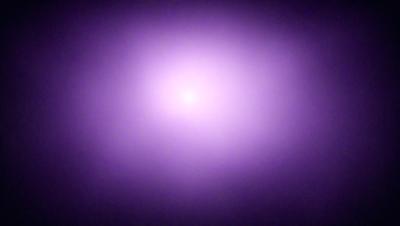The primary subject of the image is a purple, pink, and white nebula. The setting is a dark, starry sky, and the visual style is a digital art or illustration. The dominant colors and overall atmosphere of the image are purple, pink, and white, creating a sense of wonder and awe.