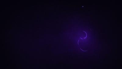 The image is a purple background with a few yellow circles. The primary subject is the yellow circles, which are the main focus of the image. The setting is a dark background, and the visual style appears to be a digital art or illustration. The colors and mood of the image are predominantly purple and yellow, creating a unique and eye-catching visual effect.