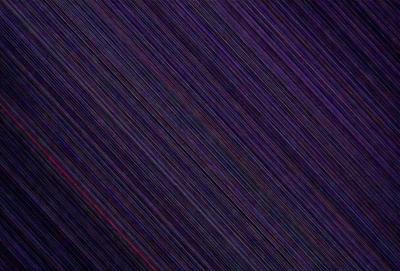 The primary subject of the image is a purple background with a pattern of red streaks. The setting appears to be a dark, possibly nighttime, environment. The visual style of the image is a combination of a photo and a digital art, as it features a blend of natural elements and artistic patterns. The dominant colors in the image are purple and red, creating a moody and dramatic atmosphere.