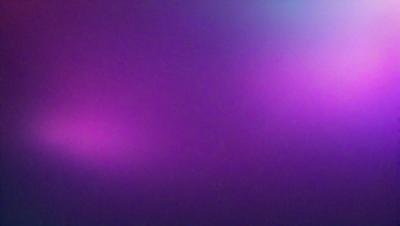 The primary subject of the image is a purple background. The setting is a dark, purple-colored room. The visual style is a close-up of the purple background, which creates a moody and atmospheric mood.