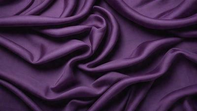 Purple fabric with a flowing pattern.