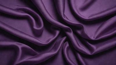 Purple fabric with a pattern of swirls and waves.