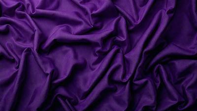 Purple fabric with a wrinkled texture.