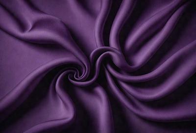 The primary subject of the image is a purple fabric, which is the main object, scene, or focus of the image. The setting or background is a dark background, which contrasts with the purple fabric. The visual style of the image is a close-up of the purple fabric, showcasing its texture and pattern. The colors and mood of the image are predominantly purple, creating a calm and serene atmosphere.
