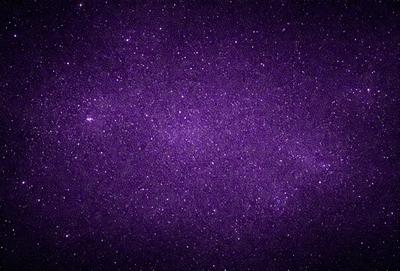 The primary subject of the image is a purple sky filled with stars. The setting is a dark, star-filled sky, and the visual style is a photo. The colors and mood of the image are predominantly purple, creating a serene and peaceful atmosphere.