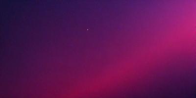 The primary subject of the image is a star, which is located in the middle of the scene. The setting is a purple sky, which creates a unique and striking visual effect. The visual style of the image is a combination of photo and digital art, as it captures the star's position in the sky while also showcasing the vibrant purple hue. The colors and mood of the image are predominantly purple, which gives it a dreamy and serene atmosphere.