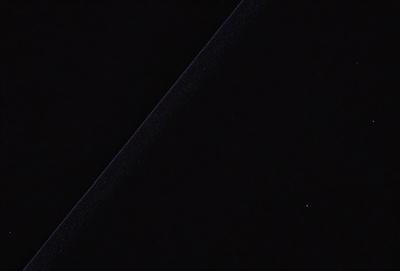 The primary subject of the image is a black background with a thin, white line running through it. The visual style appears to be a digital art or illustration, as the line is not a natural element of the environment. The colors and mood of the image are predominantly dark, with the white line being the only noticeable element.