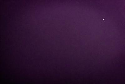 The image is a purple sky with a few stars visible. The sky appears to be a deep purple, creating a unique and striking visual effect. The stars are scattered throughout the sky, adding a sense of depth and dimension to the scene. The overall atmosphere of the image is serene and peaceful, with the purple sky and the stars providing a sense of calmness and tranquility.