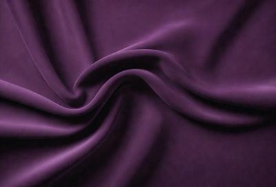 The primary subject of the image is a purple fabric, which is the main object, scene, or focus of the image. The setting or background is a purple cloth, and the visual style is a photo. The colors and mood of the image are predominantly purple, creating a calm and serene atmosphere.