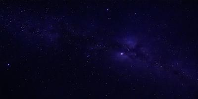 The primary subject of the image is the night sky filled with stars. The setting is a dark, star-filled sky, and the visual style is a photo of the night sky. The colors and mood of the image are predominantly dark and serene, with the stars providing a sense of wonder and tranquility.