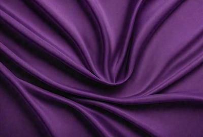 The primary subject of the image is a purple fabric, which is the main object, scene, or focus of the image. The setting or background is a purple curtain, and the visual style is a close-up of the fabric. The colors and mood of the image are predominantly purple, creating a calm and serene atmosphere.