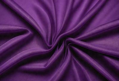 The primary subject of the image is a purple fabric, which is the main object, scene, or focus of the image. The setting or background is a purple sheet, and the visual style is a close-up of the fabric. The colors and mood of the image are predominantly purple, creating a calm and serene atmosphere.