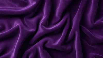 The primary subject of the image is a purple fabric, which is the main object, scene, or focus of the image. The setting or background is a purple sheet, and the visual style is a photo. The colors and mood of the image are predominantly purple, creating a calm and soothing atmosphere.