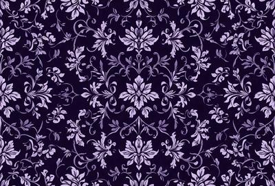 The primary subject of the image is a purple floral pattern, which is the main object, scene, or focus of the image. The setting or background is a purple fabric, and the visual style is a close-up of the floral pattern. The colors and mood of the image are predominantly purple, with a slightly darker tone, creating a calm and serene atmosphere.