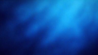 The primary subject of the image is a blue ocean with a few ripples. The setting is a vast expanse of water, and the visual style is a photo. The colors and mood of the image are predominantly blue, creating a serene and calming atmosphere.