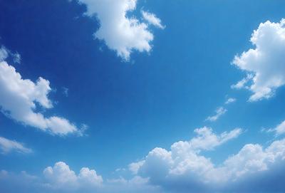 The primary subject of the image is the sky, which is filled with clouds. The setting is a clear blue sky, and the visual style is a photo. The colors in the image are predominantly blue and white, creating a calm and serene atmosphere.