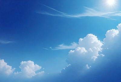The primary subject of the image is a cloudy blue sky with white clouds. The setting is a clear day with a blue sky, and the visual style is a natural, outdoor scene. The colors and mood of the image are predominantly blue and serene, creating a peaceful atmosphere.
