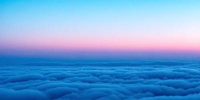 The primary subject of the image is a beautiful view of the sky, featuring a cloudy blue background. The setting is a vast expanse of the sky, with no visible land or other objects. The visual style of the image is a photo, capturing the natural beauty of the clouds and the sky. The colors and mood of the image are predominantly blue, creating a serene and peaceful atmosphere.