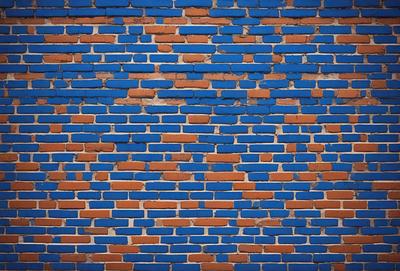 The primary subject of the image is a blue brick wall. The setting is a brick wall with a blue tint, and the visual style is a close-up of the brick wall. The colors and mood of the image are predominantly blue, creating a calm and serene atmosphere.