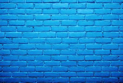 The primary subject of the image is a blue brick wall. The setting is a blue brick wall, and the visual style is a photo. The dominant colors are blue and white, creating a calm and serene atmosphere.