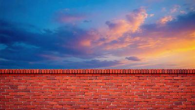 The primary subject of the image is a brick wall. The setting is a cloudy sky, and the visual style is a photo. The dominant colors are red and purple, creating a warm and moody atmosphere.