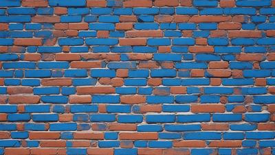The primary subject of the image is a brick wall with blue and orange bricks. The setting is a brick wall, and the visual style is a photo. The dominant colors are blue and orange, creating a warm and vibrant atmosphere.