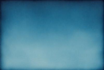 The primary subject of the image is a blue sky with clouds. The setting is a vast, open space with no visible landmarks or objects. The visual style is a natural, outdoor scene with a focus on the sky and clouds. The colors and mood are predominantly blue and serene, creating a peaceful and tranquil atmosphere.