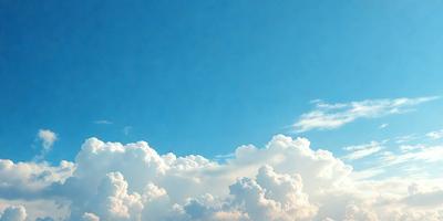 The primary subject of the image is a cloudy blue sky with white clouds. The setting is a vast, open space with no visible landmarks or objects. The visual style is a natural, outdoor scene with a focus on the sky and clouds. The colors and mood are predominantly blue and white, creating a serene and peaceful atmosphere.