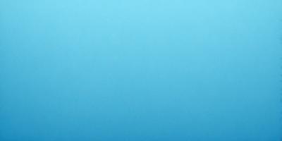 The primary subject of the image is a large, open, and empty blue sky. The setting is a vast, cloudless expanse, with no visible landmarks or objects. The visual style is a natural, untouched landscape, with no indication of digital manipulation or artistic elements. The colors and mood are predominantly blue, conveying a sense of tranquility and vastness.