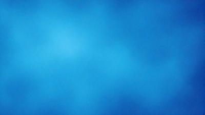 The primary subject of the image is a blue sky with a few clouds. The setting is a clear day with a cloudy sky, and the visual style is a natural, outdoor scene. The colors and mood of the image are predominantly blue, creating a calm and serene atmosphere.
