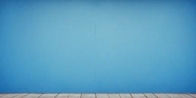 The primary subject of the image is a blue wall with a crack in it. The setting is a room with a wooden floor. The visual style is a photo, and the dominant colors are blue and white. The overall atmosphere is calm and serene.