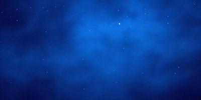 The primary subject of the image is the night sky, which is filled with stars. The setting is a dark, cloudy night, with the stars shining brightly against the backdrop of the night sky. The visual style of the image is a photo, capturing the beauty of the night sky and the stars. The colors and mood of the image are predominantly dark and moody, with the stars providing a touch of brightness and contrast.