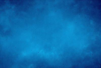 The primary subject of the image is a blue sky filled with white clouds. The setting is a vast, open space with no visible landmarks or objects. The visual style is a natural, outdoor scene with a focus on the sky and clouds. The colors and mood are predominantly blue and serene, creating a peaceful and tranquil atmosphere.